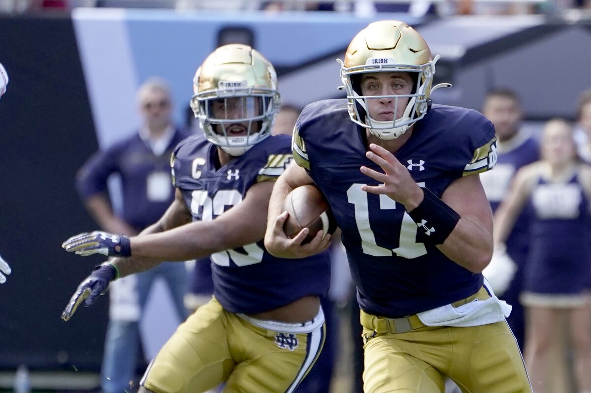 Notre Dame quarterback Jack Coan carries the ball during a win over Wisconsin on Sept. 25.