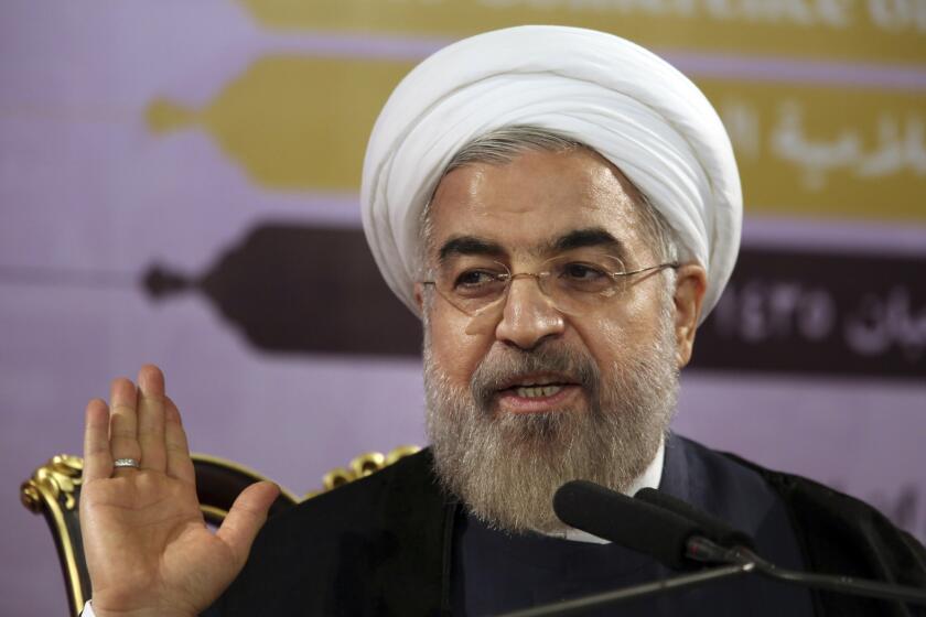 Iranian President Hassan Rouhani gestures as he speaks during a press conference in Tehran.