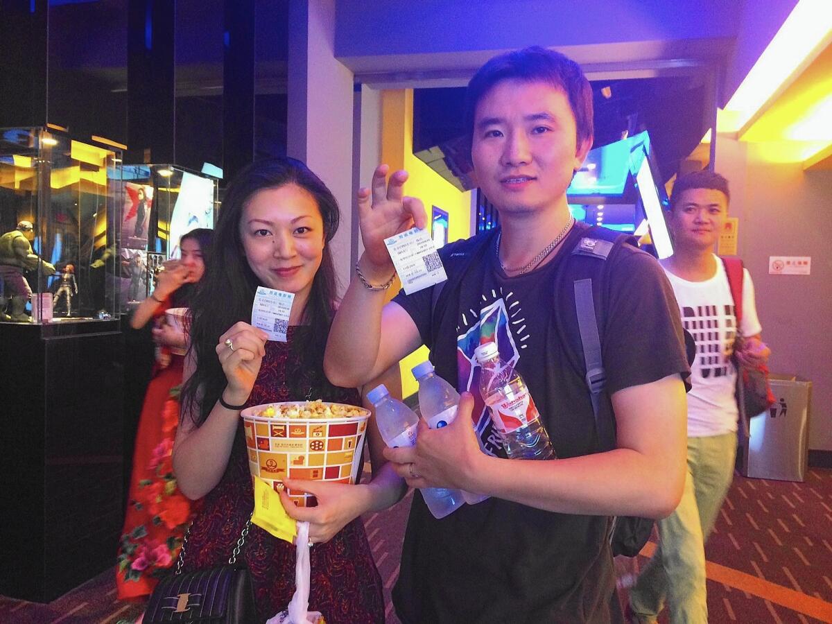 Zhou Yuan, 31, and Zhang Chao, 36, head into a screening of "Jurassic World" in Beijing on June 16, 2015.