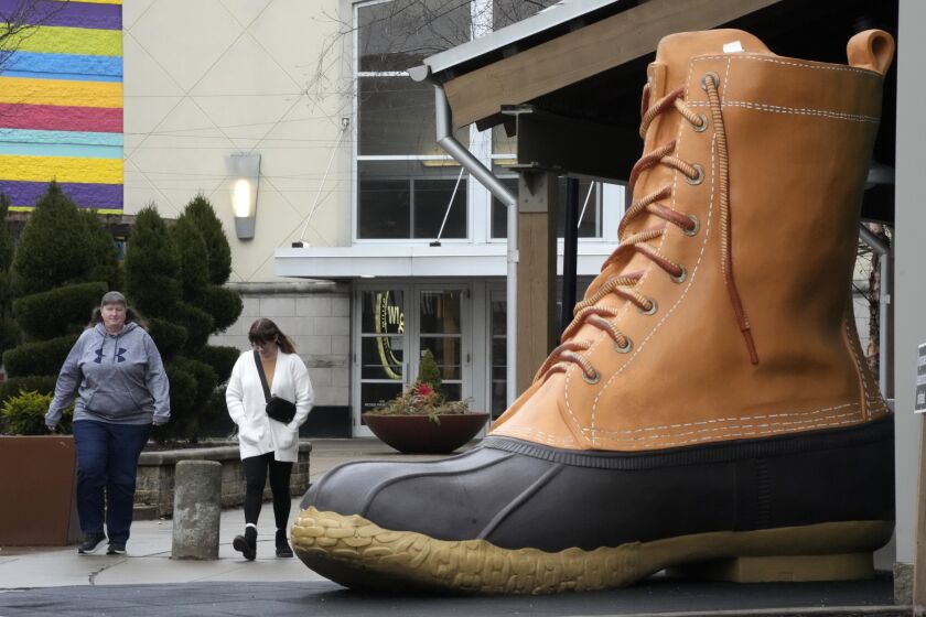Shoppers pass an large L.L. Bean boot displayed outside an L.L. Bean store in Pittsburgh on Monday, Jan. 30, 2023. On Wednesday, the Commerce Department releases U.S. retail sales data for January. (AP Photo/Gene J. Puskar)