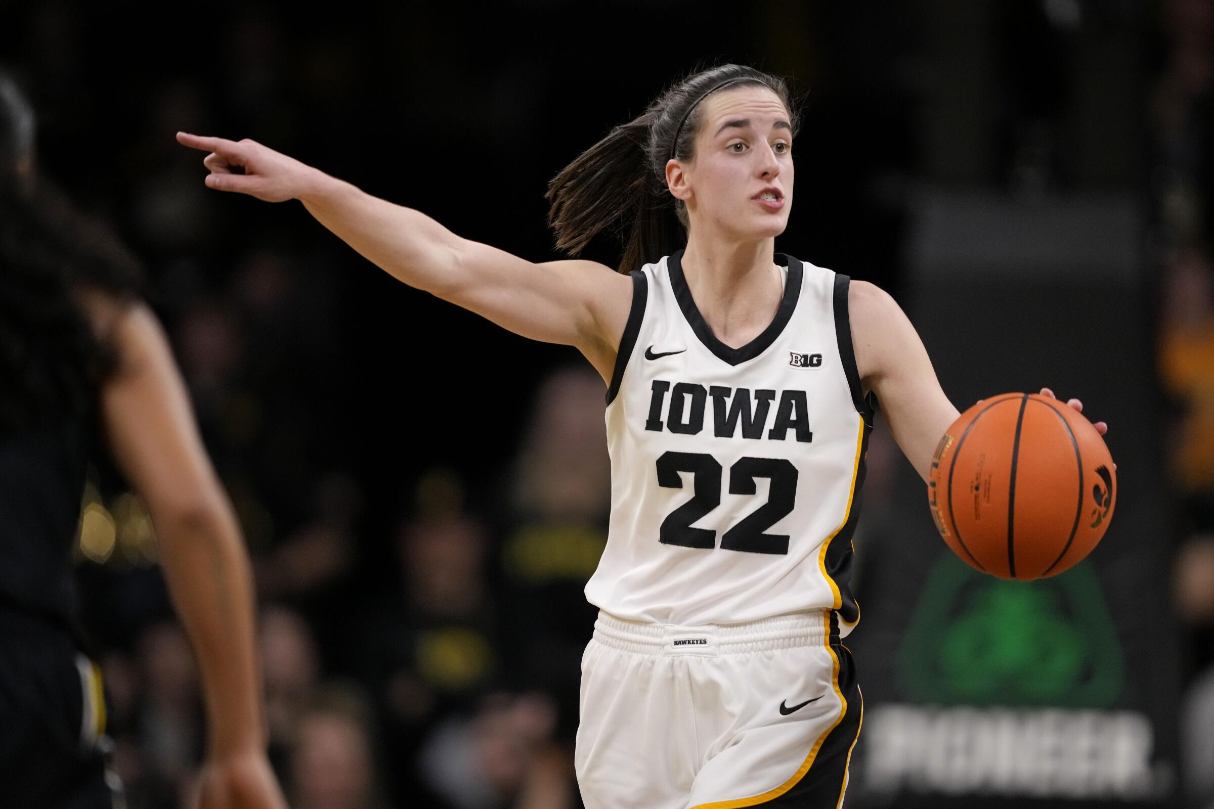 Iowa guard Caitlin Clark directs her teammates while setting up the offense.