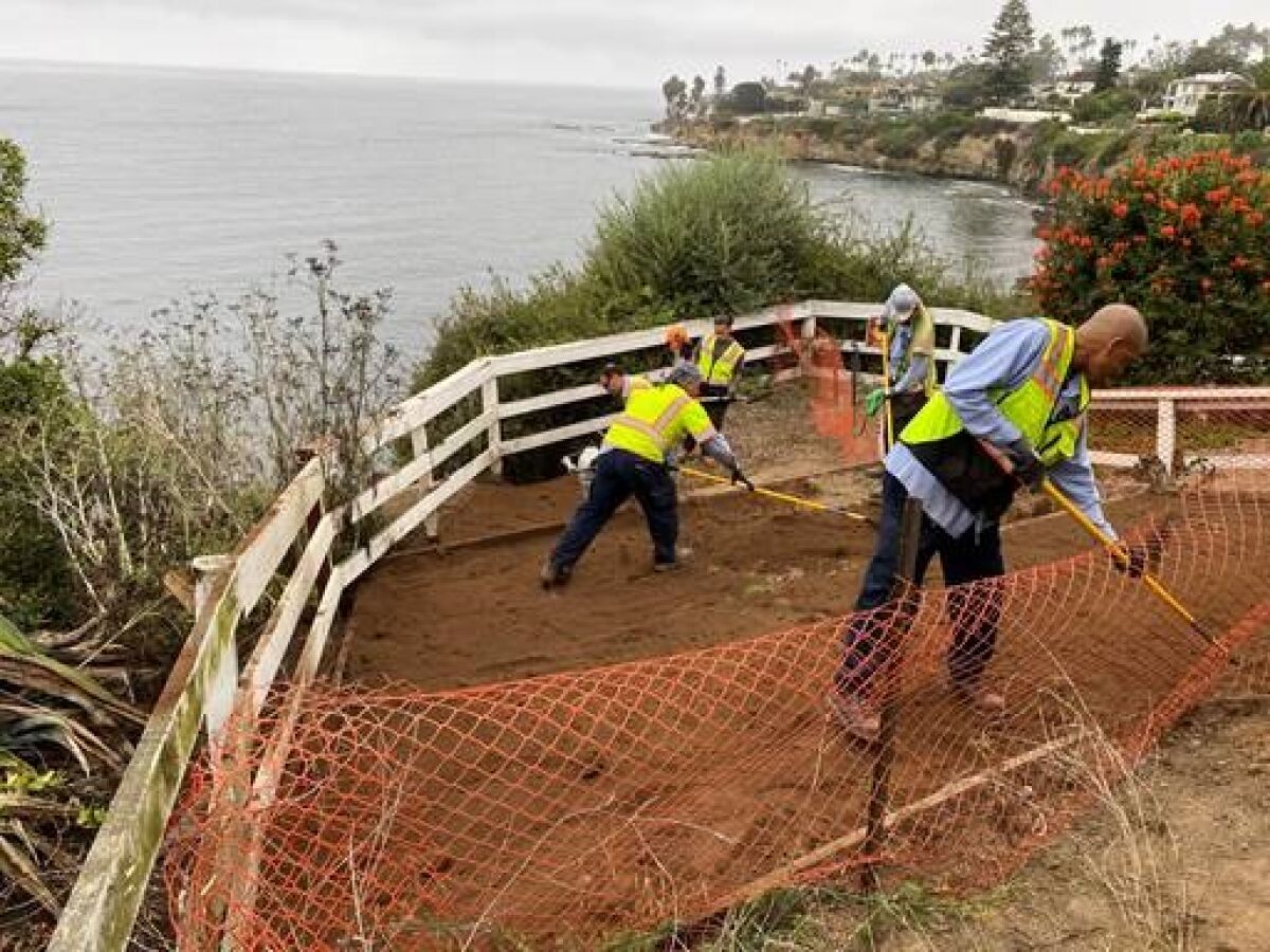 Workers complete storm drain repairs at the edge of La Jolla Hermosa Park.