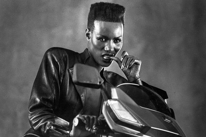 1985: Grace Jones poses for Los Angeles Times staff photographer Larry Davis during a break in the shooting of a Honda motor scooter commercial. This photo appeared in the May 19, 1985, Los Angeles Times.