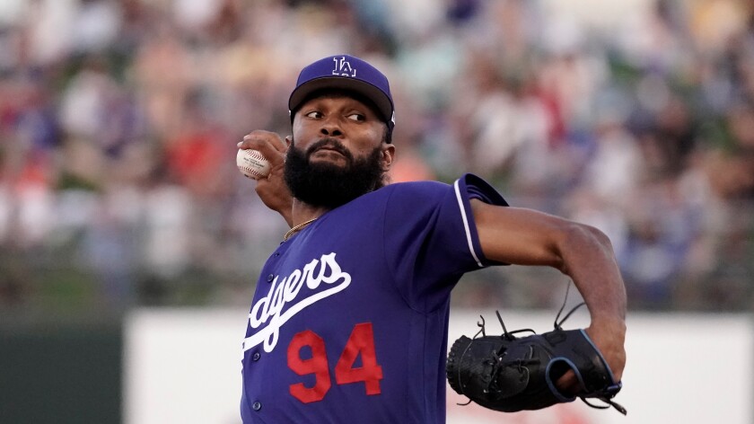 Dodgers pitcher Andre Jackson throws during a spring training game against the Royals 