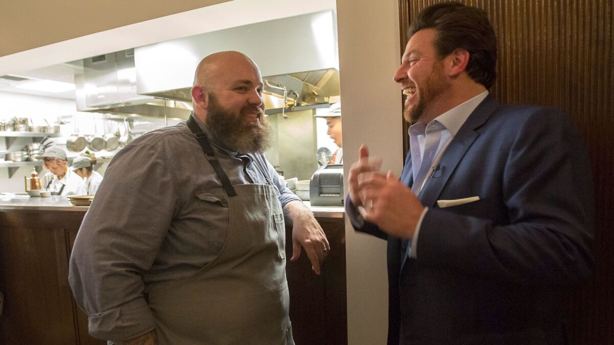 Chef and pasta maker Evan Funke (left) of Felix Trattoria chats with chef Scott Conant following dinner at the Venice restaurant. (Myung J. Chun / Los Angeles Times)