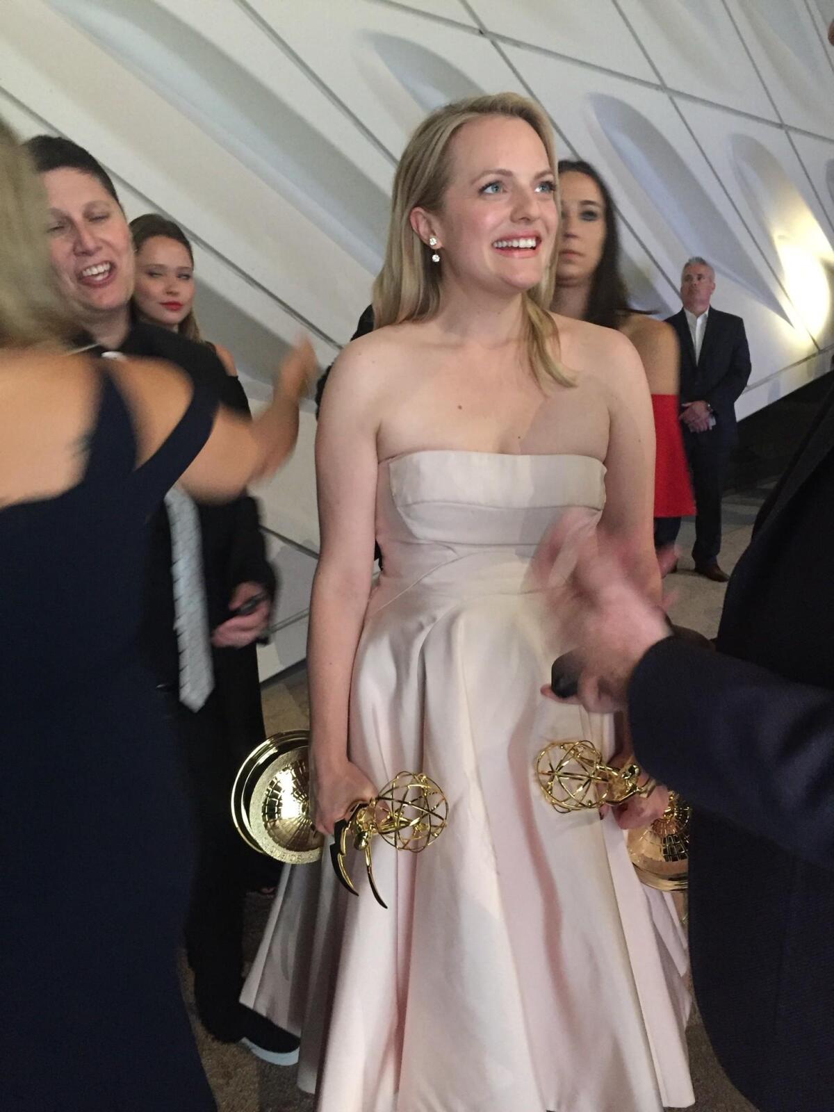Elisabeth Moss from "The Handmaid's Tale" clutches her two Emmys.