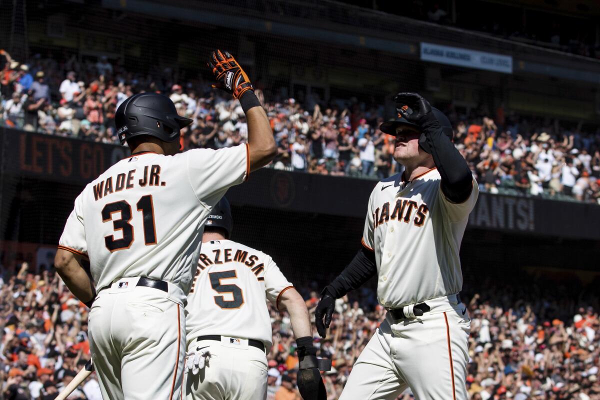 San Francisco's Logan Webb, right, celebrates with teammate LaMonte Wade Jr.