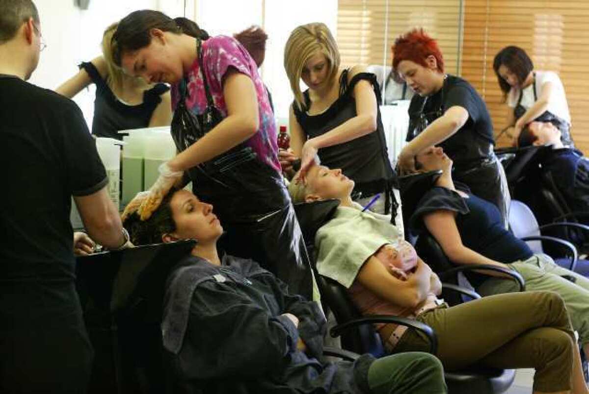 Students with customers at the Vidal Sassoon Academy.