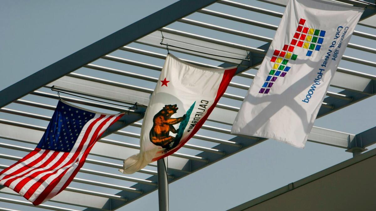 Flags fly outside West Hollywood City Hall. A Los Angeles jury Friday ruled in favor of the city in a trial with allegations of wrongful termination and retaliation.