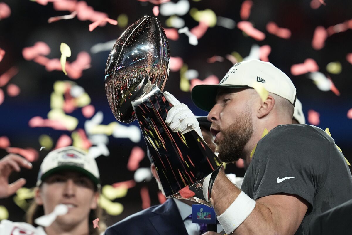 Kansas City tight end Travis Kelce celebrates with the Vince Lombardi Trophy after the Chiefs' Super Bowl LVII win Sunday.