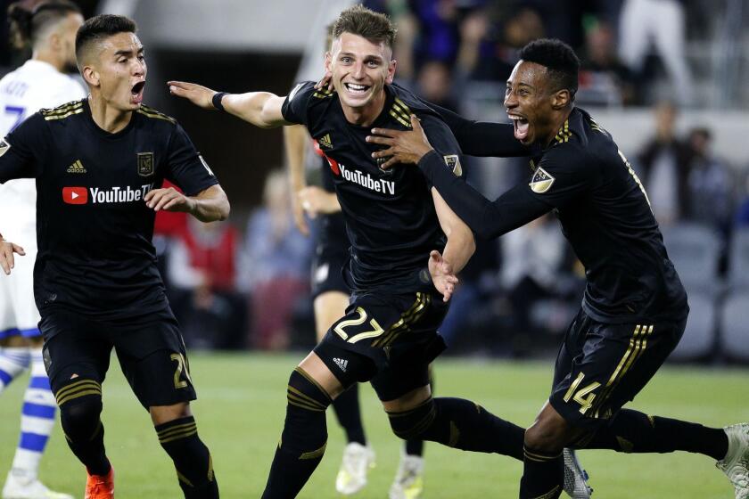 Los Angeles FC defender Tristan Blackmon (27), celebrates his goal with forward Christian Ramirez (21) and midfielder Mark-Anthony Kaye (14) during the second half of an MLS soccer match against Montreal Impact in Los Angeles, Friday, May 24, 2019. LAFC won 4-2. (AP Photo/Ringo H.W. Chiu)