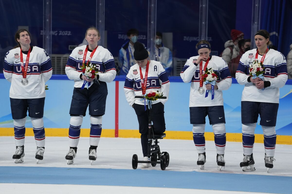 United States pose for photos after receiving their silver medals after being defeated by Canada in women's gold medal hockey game at the 2022 Winter Olympics, Thursday, Feb. 17, 2022, in Beijing. (AP Photo/Petr David Josek)