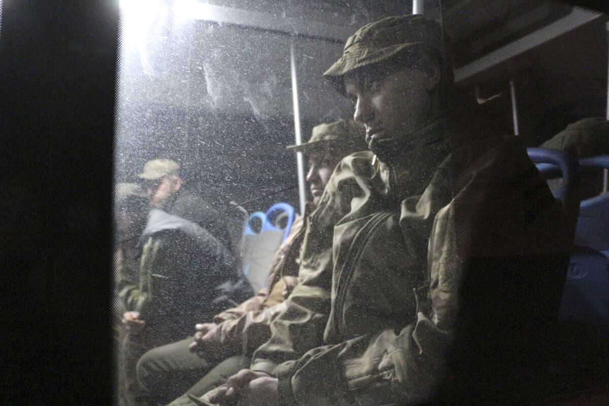 Ukrainian servicemen sit in a bus after they left the besieged Mariupol's Azovstal steel plant, near a penal colony in Olyonivka, in territory under the government of the Donetsk People's Republic, eastern Ukraine, Friday, May 20, 2022. (AP Photo)