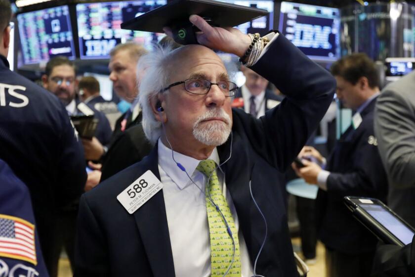 FILE- In this March 5, 2019, file photo trader Peter Tuchman works on the floor of the New York Stock Exchange. The U.S. stock market opens at 9:30 a.m. EDT on Wednesday, March 27. (AP Photo/Richard Drew, File)