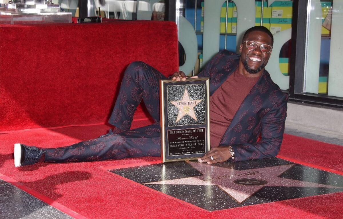 Kevin Hart lies down next to his star during a ceremony honoring him on the Hollywood Walk of Fame in Hollywood on Oct. 10. Hart received the 2,591th star in the Live Performance category.