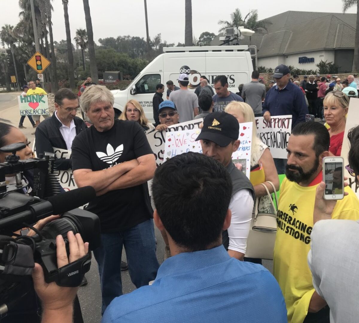 Horse-racing protesters and counter-protesters gather Thursday, Aug. 22, before a regularly-scheduled meeting of the California Horse Racing Board in Del Mar.