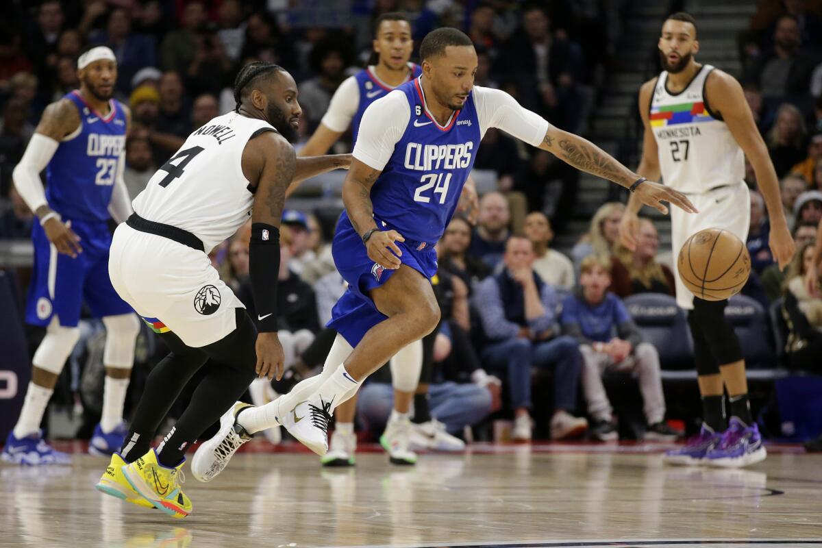 The Clippers' Norman Powell steals the ball from the Timberwolves' Jaylen Nowell on Jan. 6, 2023.