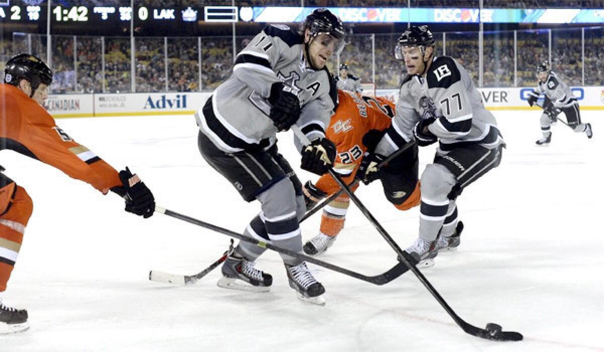 Anze Kopitar, center, controls the puck during the Kings and Ducks' outdoor game in January as part of the NHL's Stadium Series at Dodger Stadium.