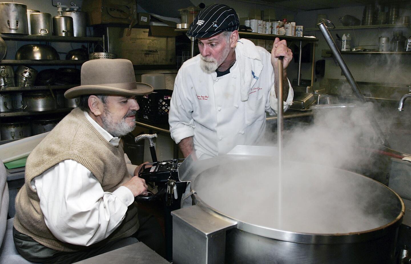 Chef Paul Prudhomme, left, talks with Cannon Wiest as he looks at the stock pot at his French Quarter restaurant, K-Paul's Louisiana Kitchen, in New Orleans, in 2007.