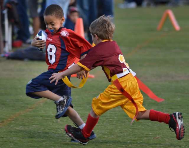 Aaron Arterberry (28) of the Arizona Wildcats runs with the ball as Trenton Quick (3) tries to capture the flag.