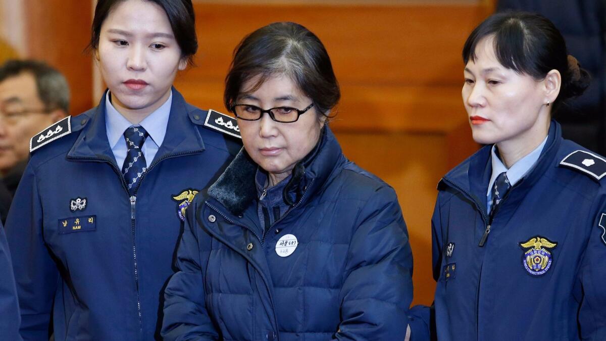 Choi Soon-sil, center, appears in Seoul's Constitutional Court on Jan. 16.