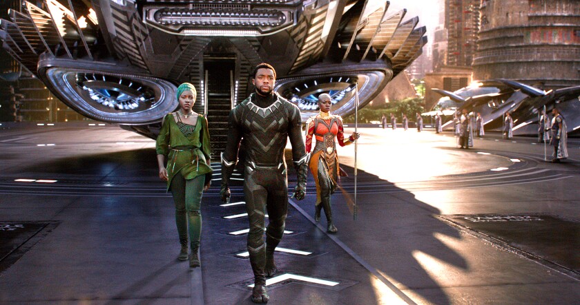 Nakia, Black Panther and Okoye walk in front of a futuristic aircraft