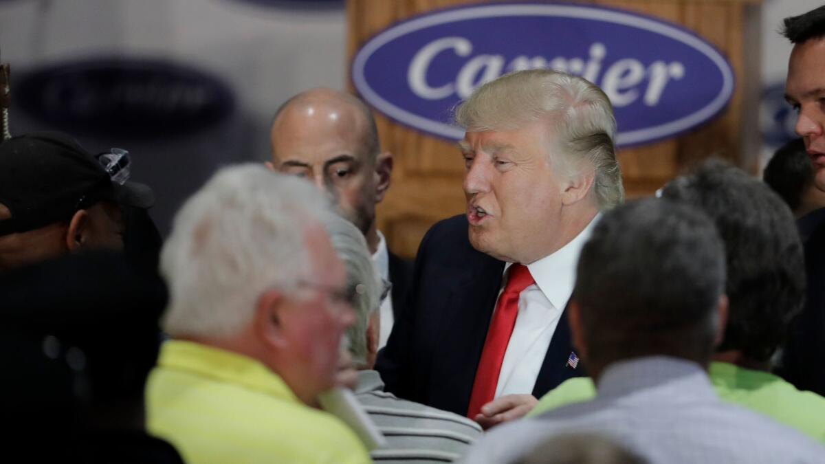 Donald Trump, then the president-elect, mingles with Carrier Corp. factory workers in Indianapolis after announcing a job-saving deal on Dec. 1.