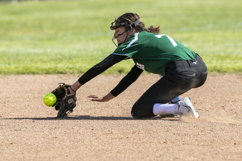 Costa Mesa, CA - April 05: Costa Mesa's isabella Gonzalez makes a backhanded stop on a ball during the Battle for the Bell game against Estancia on Wednesday, April 5, 2023 in Costa Mesa, CA. (Scott Smeltzer / Daily Pilot)