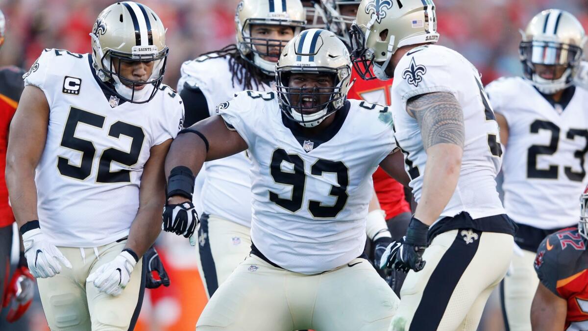 David Onyemata celebrates with his Saints teammates after making a tackle for loss against the Tampa Bay Buccaneers on Dec. 31.