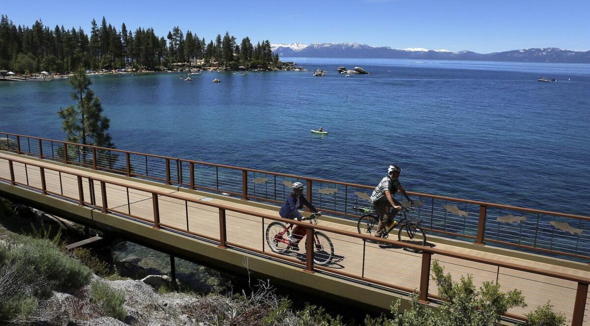 In this June 25 photo, bicyclists take a ride on the newly completed Tahoe East Shore Trail in Nevada. Authorities have been cracking down over nudity along the eastern shore of Lake Tahoe in recent weeks.