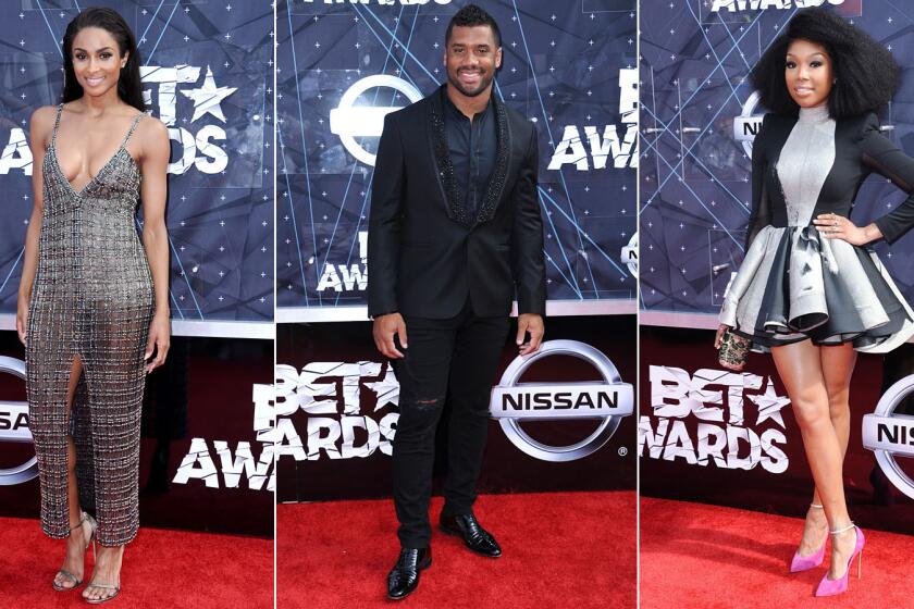 Ciara, left, Russell Wilson and Brandy Norwood arrive at the BET Awards at the Microsoft Theater.