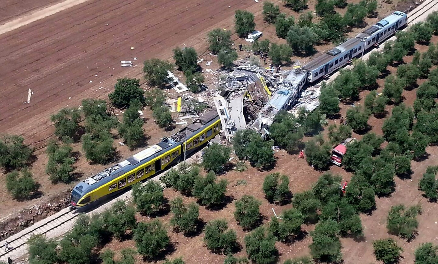 Image released by the Italian firefighters Vigili del Fuoco shows two smashed carriages thrown across the tracks after a head-on collision of two trains between Ruvo and Corato, in the southern Italian region of Puglia.