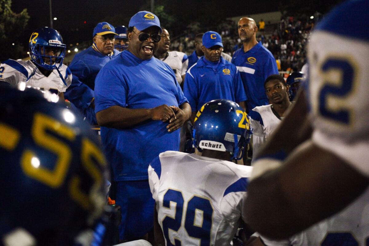 Crenshaw Coach Robert Garrett talks to his team during the second half of a game against rival Dorsey High at Jackie Robinson Stadium on October 19, 2012.