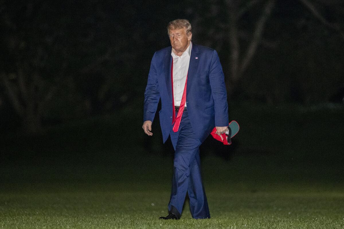  President Trump walks on the South Lawn of the White House after stepping off Marine One.