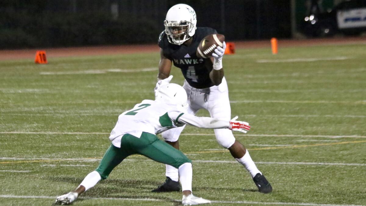 Hawkins receiver Joseph Lewis tries to avoid the tackle of Hamilton defender Dre'von Macon during the second half on Aug. 26.