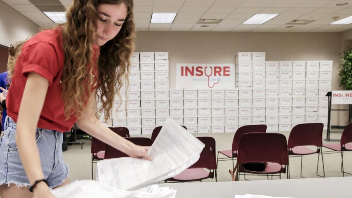 Volunteer Allie Christianson of Omaha sorts signed petitions in Lincoln, Neb. on July 5, 2018.