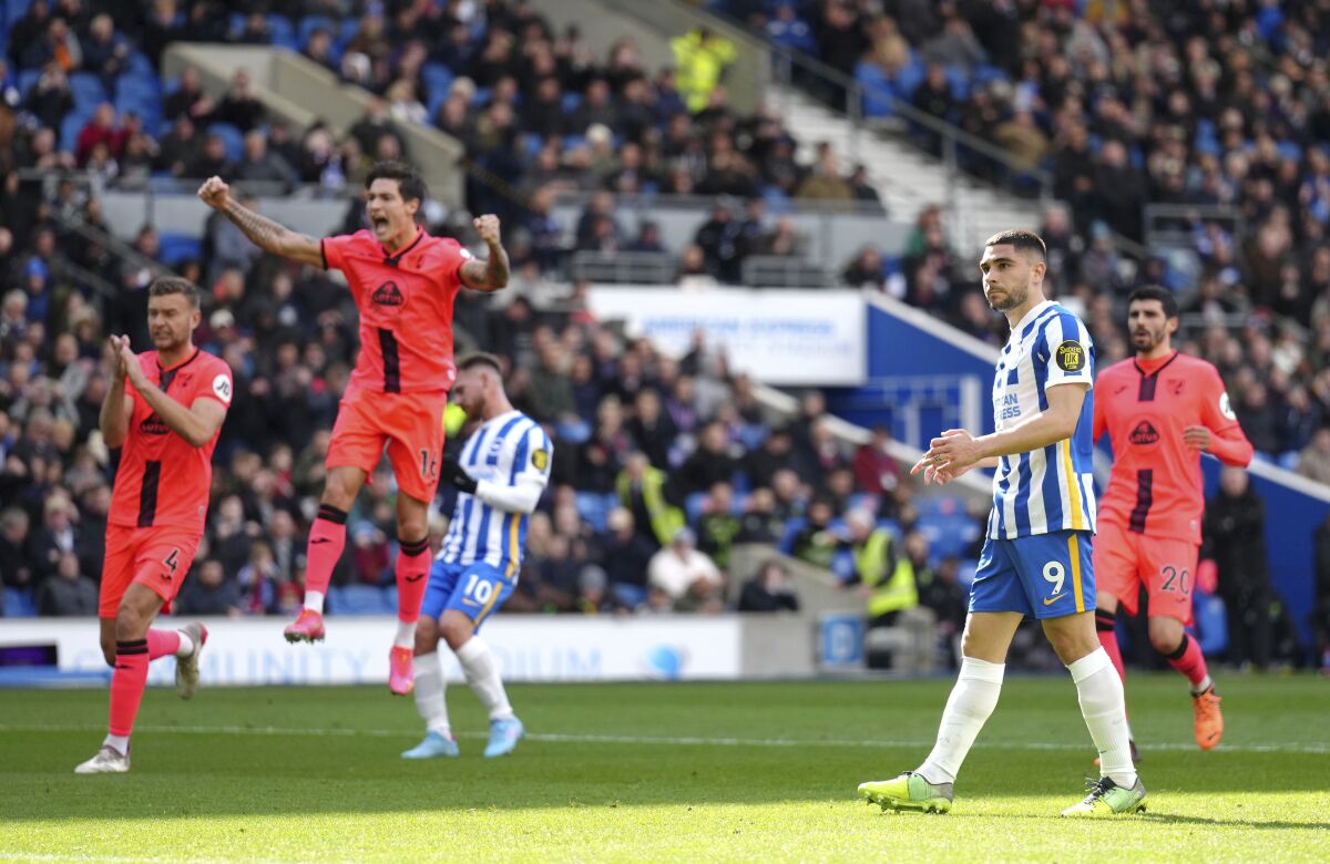 Brighton and Hove Albion's Neal Maupay reacts after failing to score a penalty kick as Brighton & Hove Albion players celebrate during the English Premier League soccer match between Brighton & Hove Albion and Norwich City, at the AMEX stadium, Brighton, England, Saturday, April 2, 2022. (John Walton/PA via AP)
