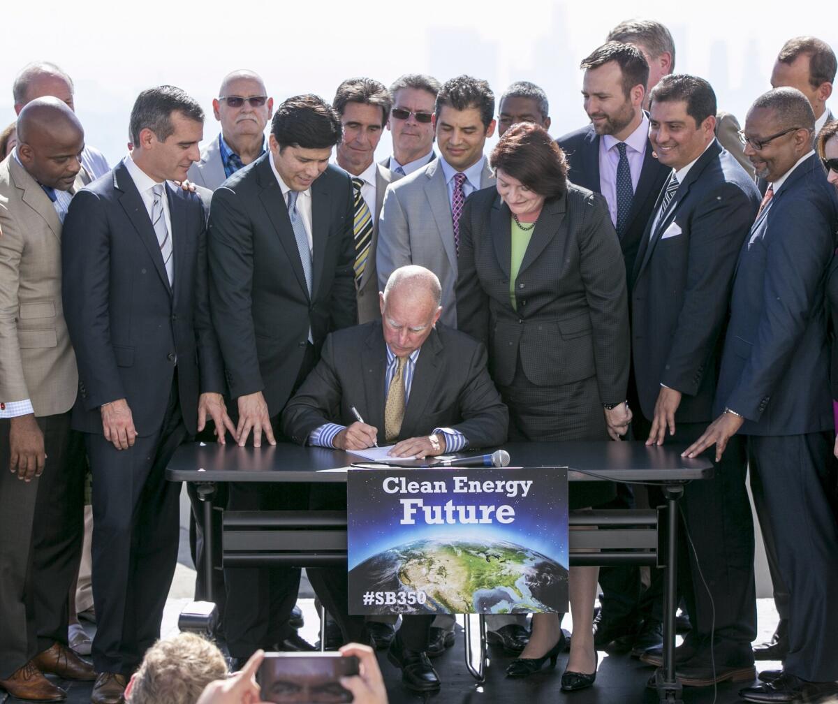 Gov. Jerry Brown signs climate-related legislation on Wednesday in Los Angeles. He signed additional environmental measures into law Thursday.