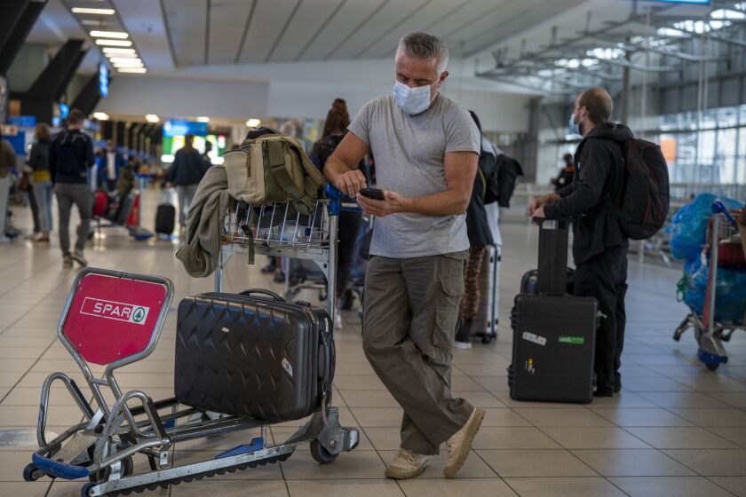 A traveler waits for a flight at an airport in Johannesburg, South Africa, on Friday.