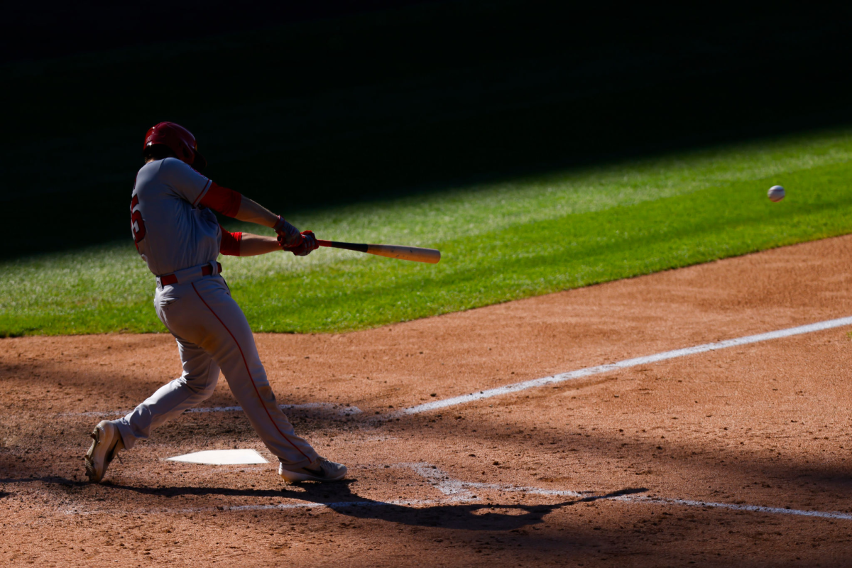 Angels first baseman Jared Walsh hits a single against the Colorado Rockies on Sunday.