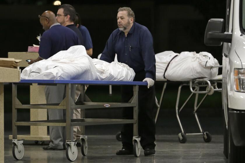 The bodies of two massacre victims arrive at the medical examiner's office in Orlando, Fla., on June 12, 2016.