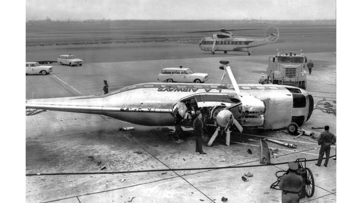March 15, 1966: Los Angeles Airways helicopter, its rotor blades broken off, rests on its side at at Los Angeles International Airport.