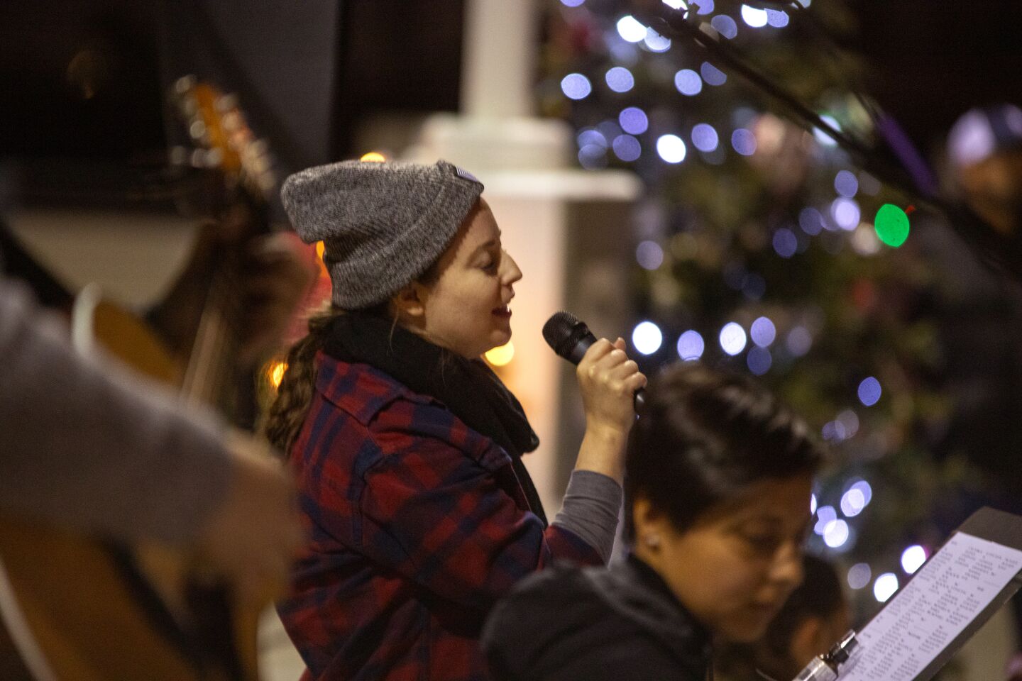 Singer Katie Hedd entertains the crowd with Christmas carols at Sunday night's Shine Bright event by First United Methodist Church of Costa Mesa.