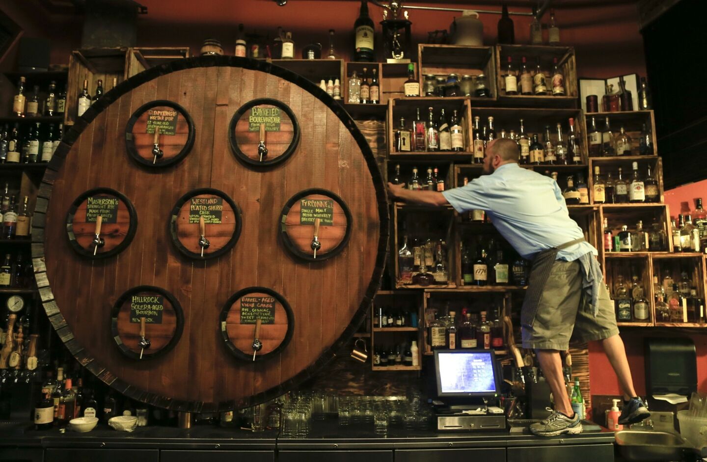 The gigantic barrel facade behind the bar houses the taps dispensing whiskey, cognac and other hard liquor at Radiator Whiskey, where the sips can be paired with comfort food.