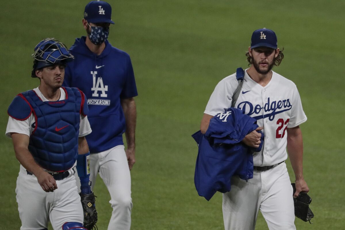 Dodgers catcher Austin Barnes, left, walks with pitcher Clayton Kershaw to the dugout before taking on the San Diego Padres.