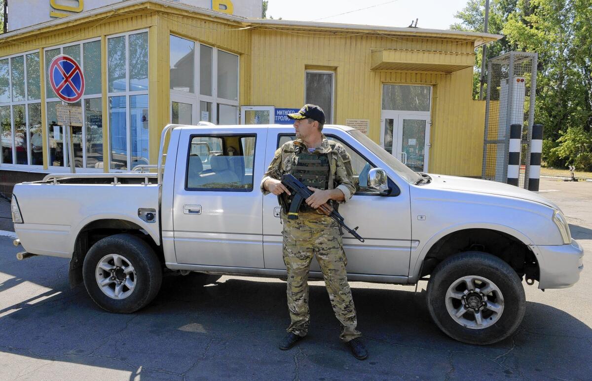 A member of Ukraine's border service patrols the seaport in Mariupol. Residents fear separatists want to seize the city for its large port on the Sea of Azov.