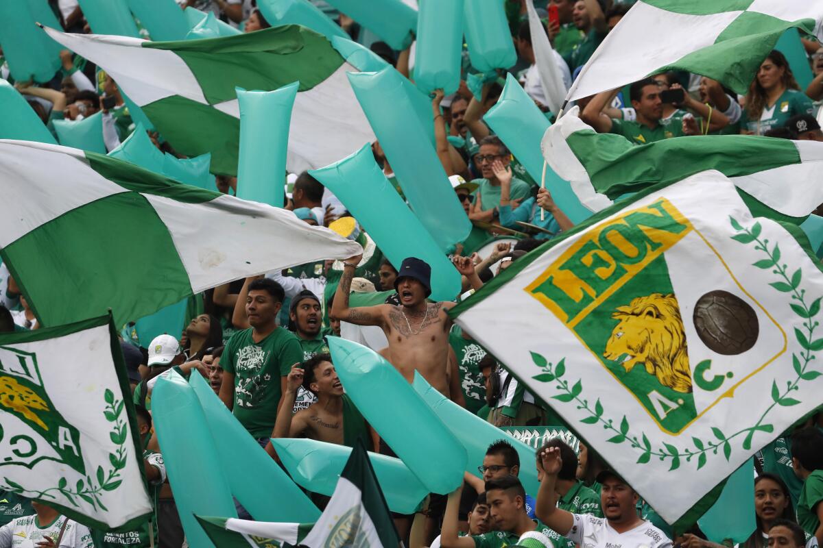 Fans of Leon cheer for their team prior to the final Mexico soccer league championship match against Tigres in Leon, Mexico, Sunday, May 26, 2019. (AP Photo/Eduardo Verdugo)