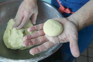 Lola 55 executive chef Andrew Bent demonstrates how to make corn tortillas on November 7, 2019 in San Diego, California. Rolling off pieces to correct size and weight for tortillas.