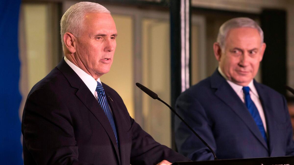 Vice President Mike Pence speaks to reporters as Israeli Prime Minister Benjamin Netanyahu listens after their meeting in the prime minister's residence in Jerusalem on Jan. 22.