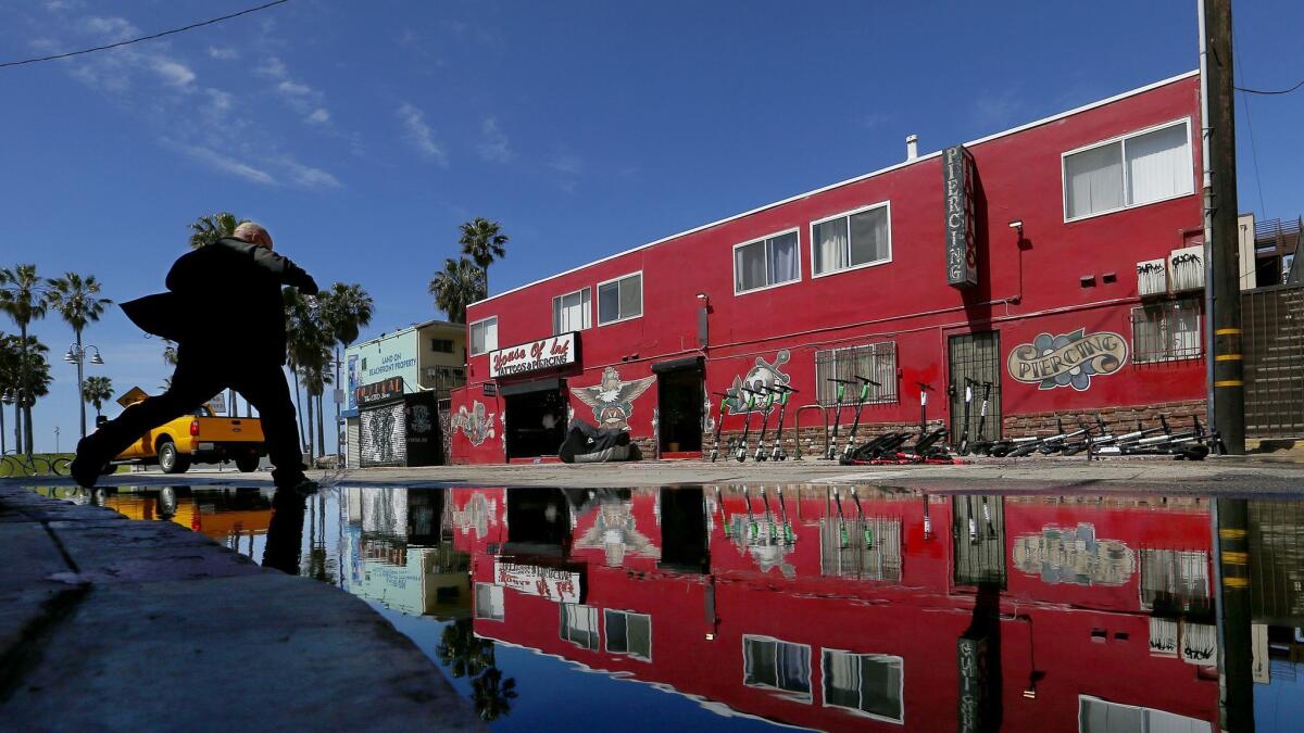 Water pools at the intersection of Horizon Avenue and Speedway in Venice Beach after a brief rainstorm on Mar. 20.